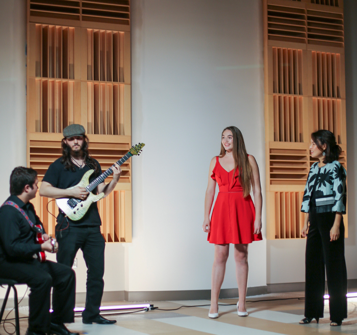 Students singing and playing the guitar