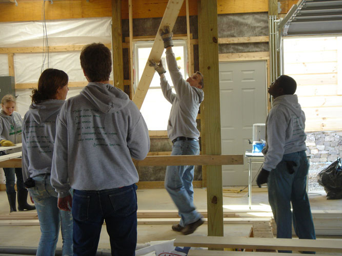 Students helping build a building