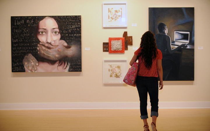 Girl looking at paintings in the gallery