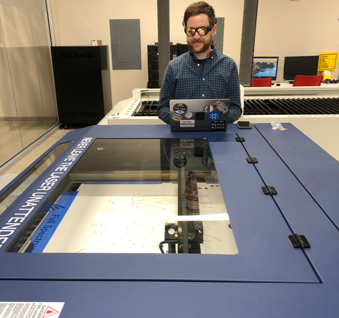 Student using a machine in the digital fabrication lab.