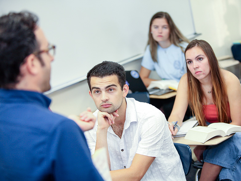English teacher speaking to students in a classroom