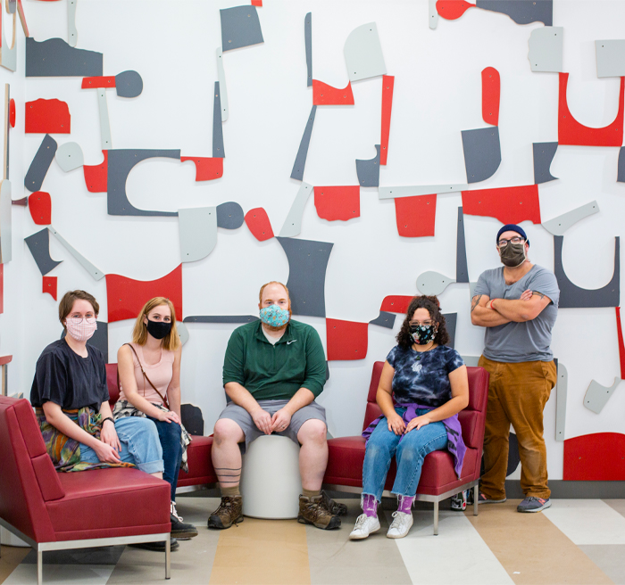 People sitting in front of accent wall 