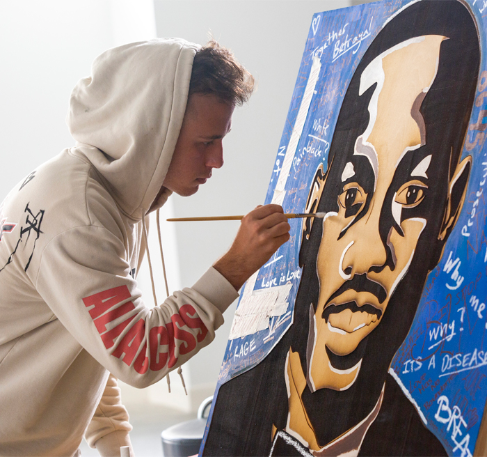 Student painting Ahmaud Arbery portrait