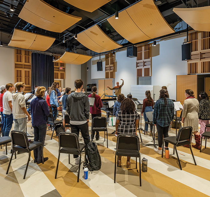Students practicing in a rehearsal room.