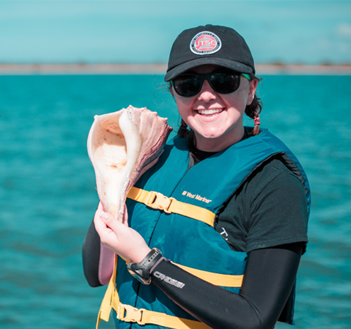 Marine Biology Student holding a conch shell