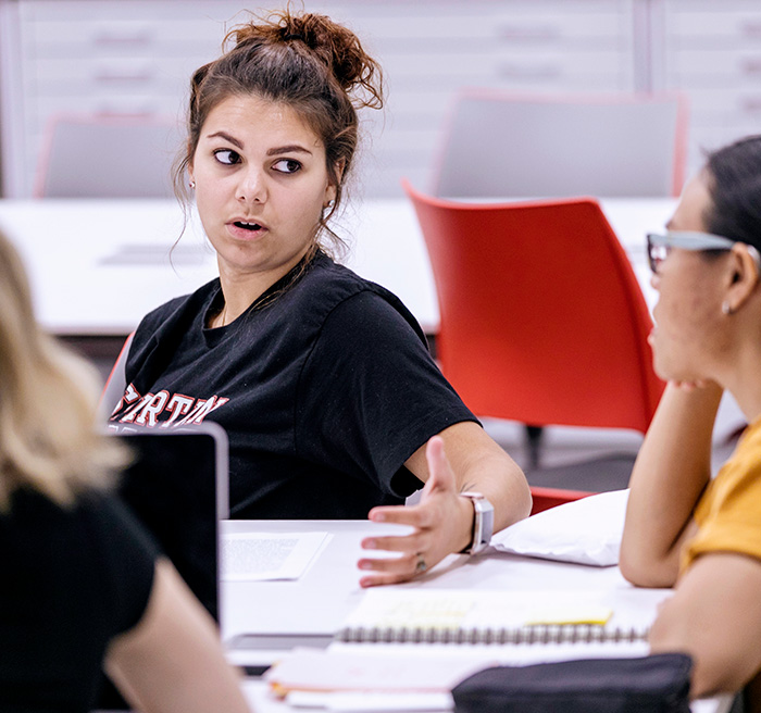 A table of students discussing policy.