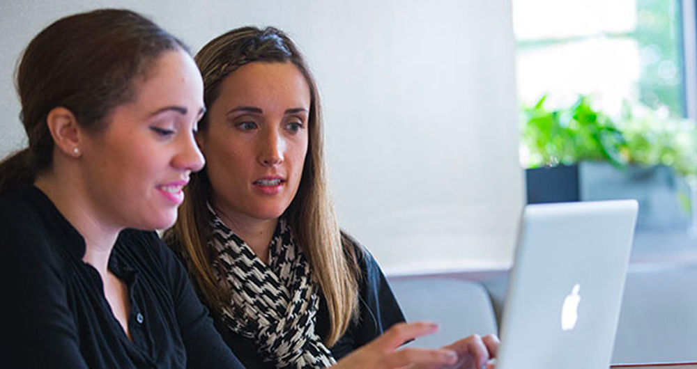 Two students looking at computer 