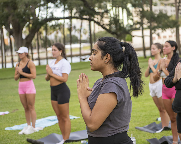 Students doing yoga in Plant Park