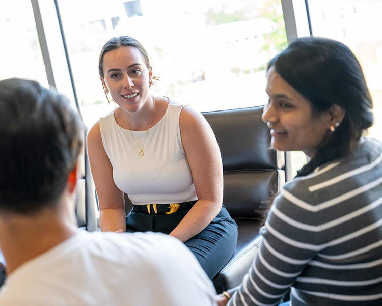 Students talk in a group.