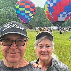 couple in front of hot air balloons 