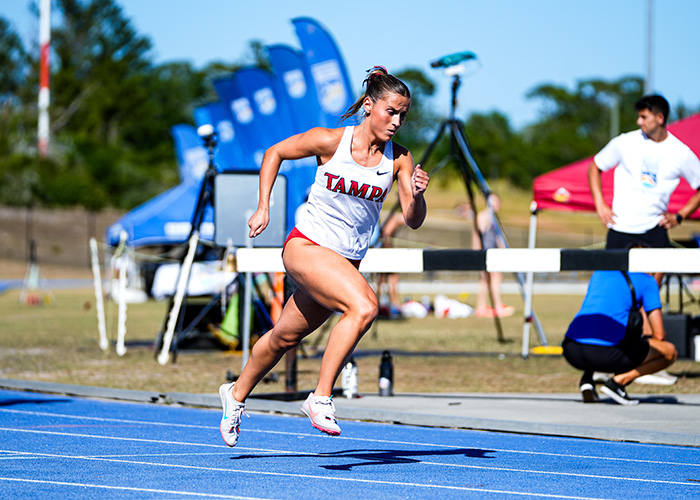 Female cross country runner competing in a race