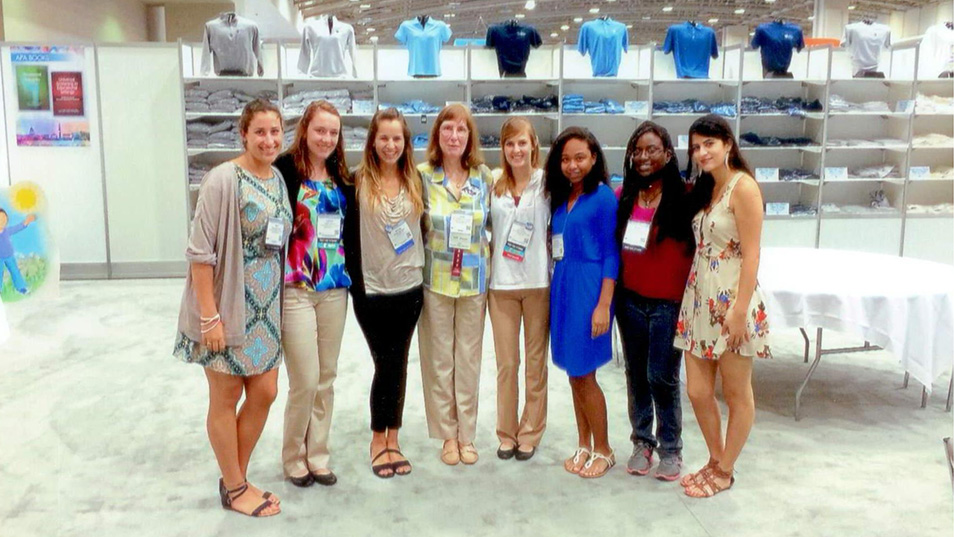 Janet Matthews is shown standing with several students