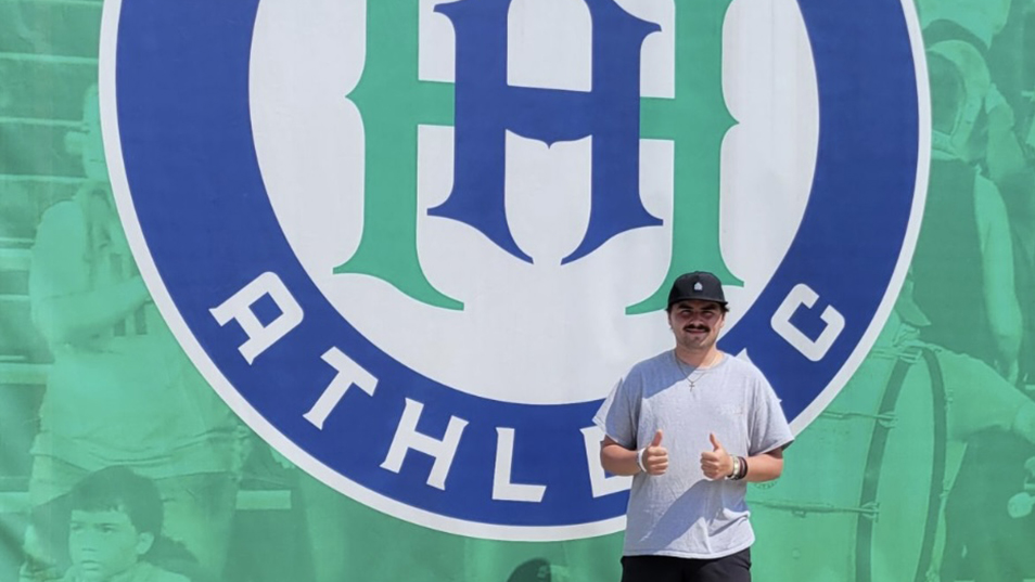 Kellen Sargolini standing in front of the Hartford Athletic team sign.