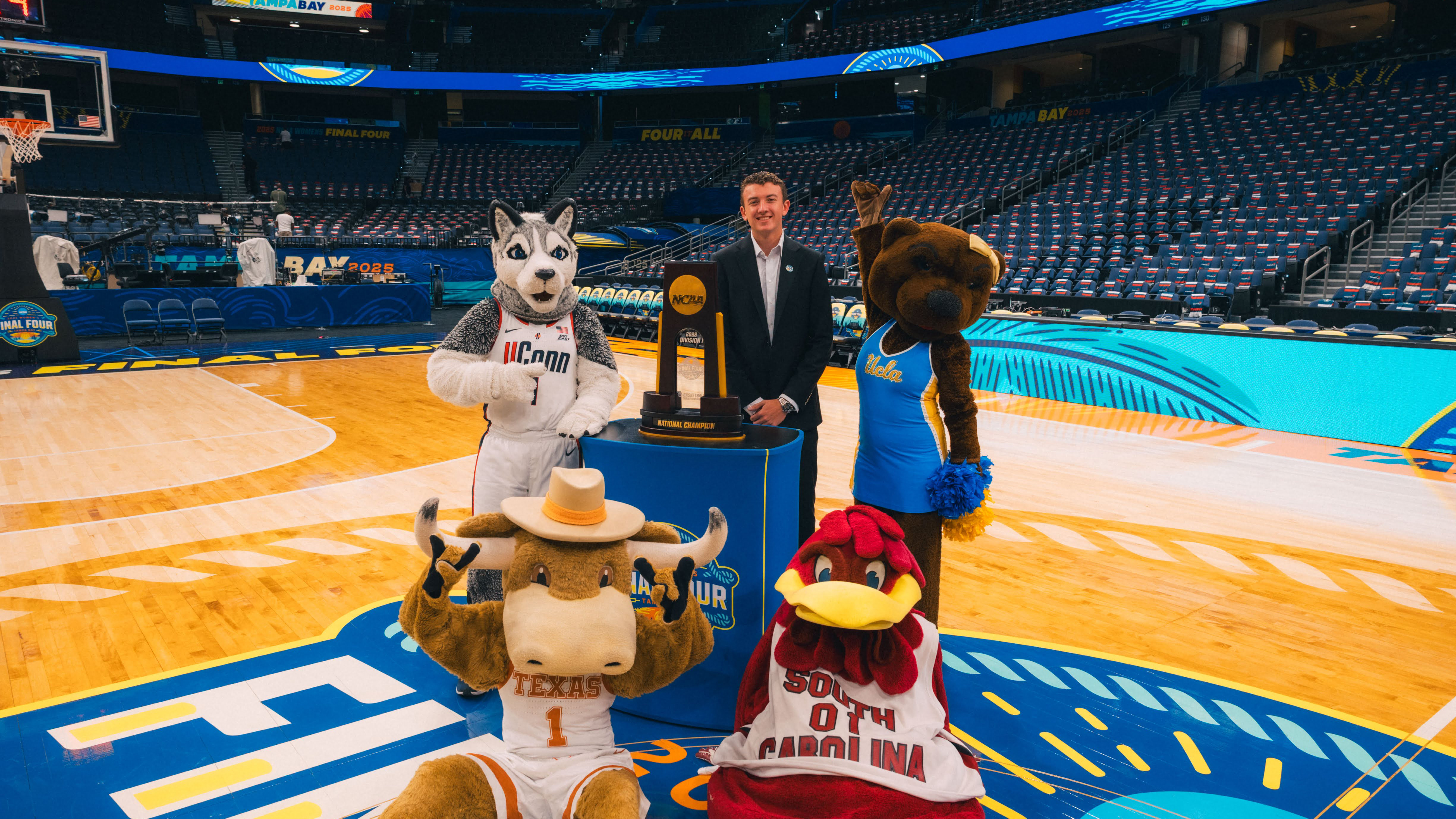 Porter Sherman on the basketball court with team mascots
